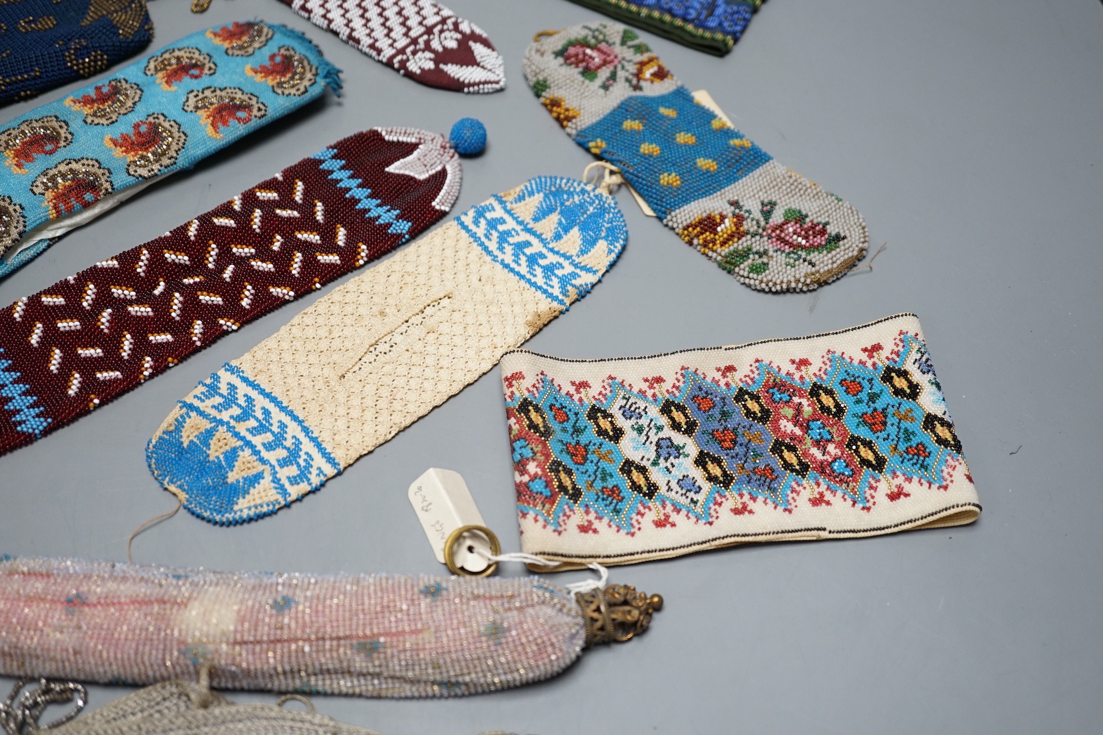 A collection of nine Berlin beadwork miser's purses and three panels, longest 26cm